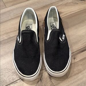 Vans Black and White Slip-On Shoes.